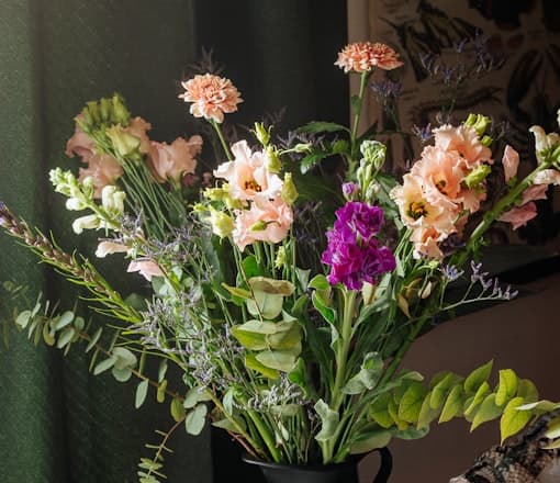 White and purple flowers in a black vase